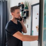 Home Environment - a man talking on a cell phone next to a painting