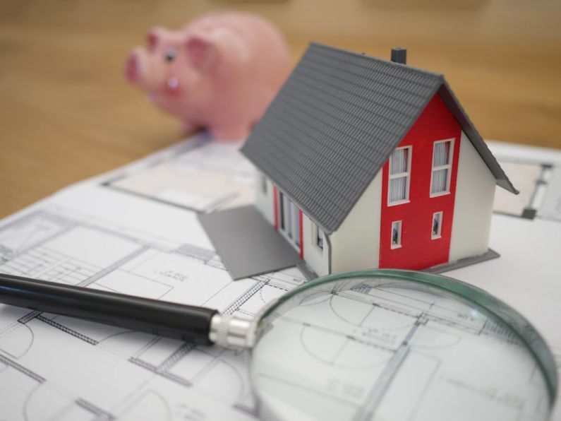 Credit - white and red wooden house beside grey framed magnifying glass