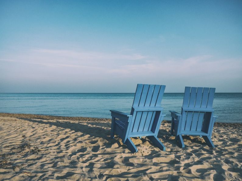 Retirement - two blue beach chairs near body of water