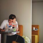 Financial Stress - man wearing white top using MacBook
