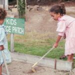 Kids - a couple of girls cleaning the ground