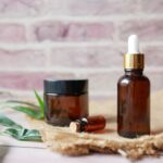 Aromatherapy - brown glass bottle on brown textile