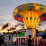 Live Performances - a carnival ride with people standing around it