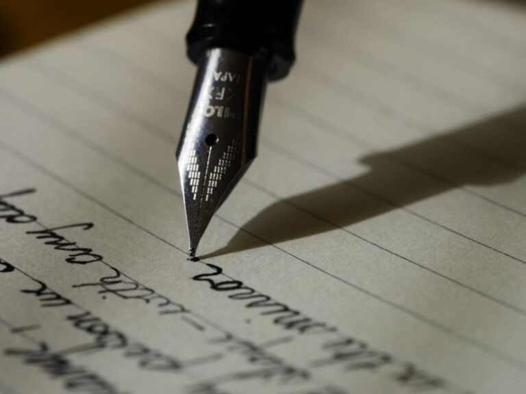 Writing - fountain pen on black lined paper