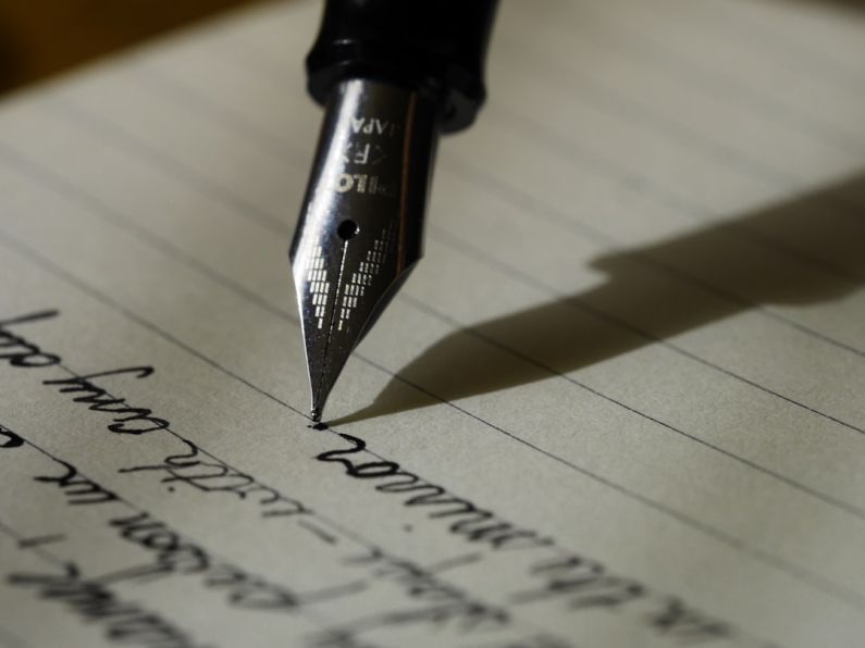 Writing - fountain pen on black lined paper