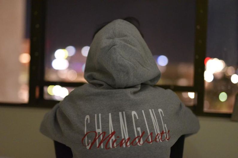 Mindset - person wearing gray and red hooded jacket facing back