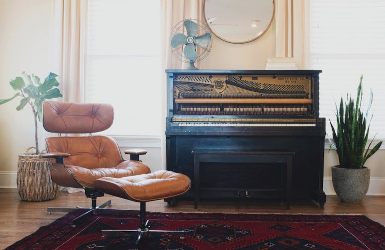 Music Therapy - black upright piano near brown leather padded chair