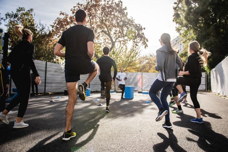 Cardio - man in black t-shirt and black shorts running on road during daytime