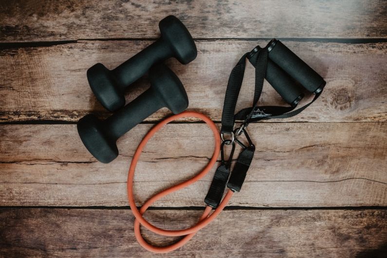Home Workouts - orange and black usb cable on brown wooden surface