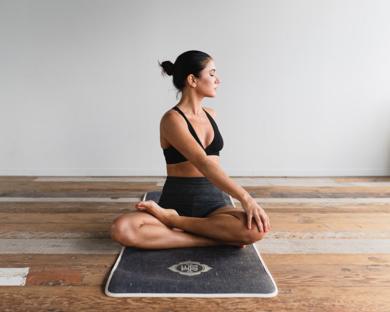 Pilates - woman performing yoga