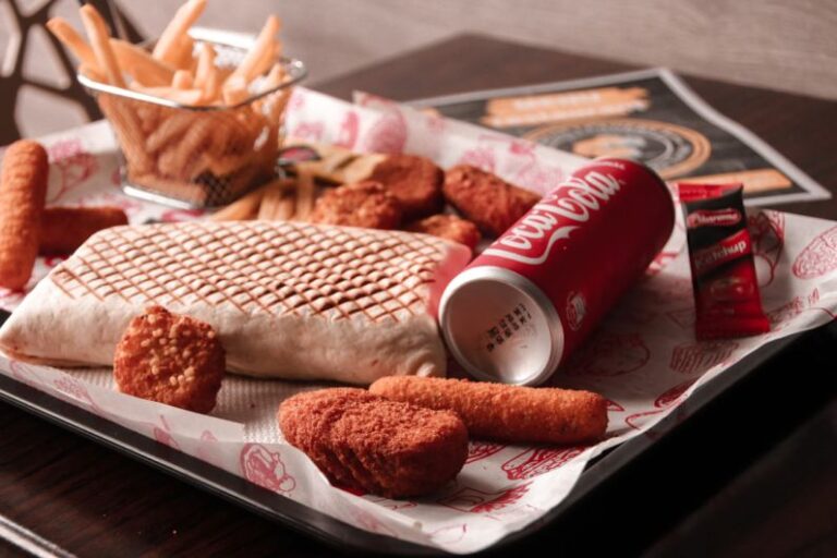 Processed Foods - red and white coca cola can beside brown bread on white ceramic plate