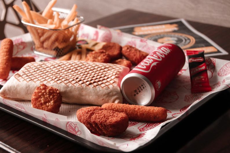 Processed Foods - red and white coca cola can beside brown bread on white ceramic plate