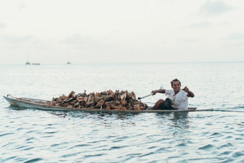 Local Culture - man riding boat during daytime