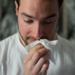 Allergies - man wiping mouse with tissue paper