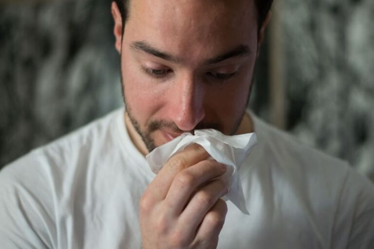 Allergies - man wiping mouse with tissue paper