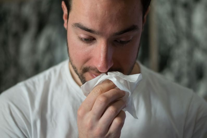Allergies - man wiping mouse with tissue paper
