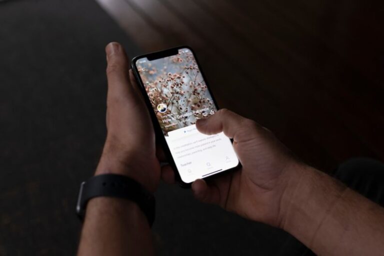 Mindfulness Apps - a person holding a cell phone in their hand