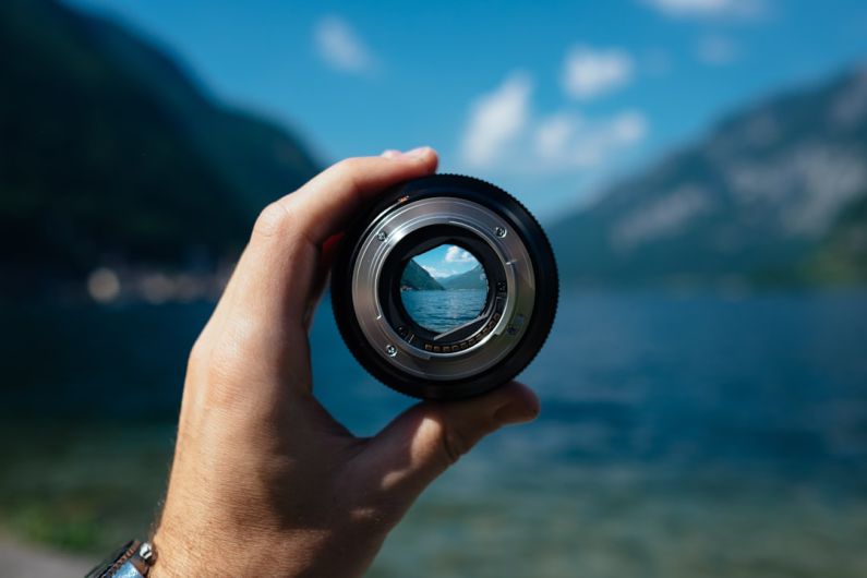 Focus - person holding camera lens