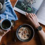Morning Routine - person holding blue ceramic mug and white magazine