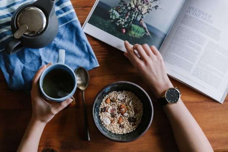 Morning Routine - person holding blue ceramic mug and white magazine