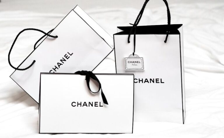 Fashion Brands - black framed sunglasses on white printer paper