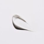 Skincare - stainless steel spoon on white surface