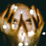 Dark Circles - woman holding string lights