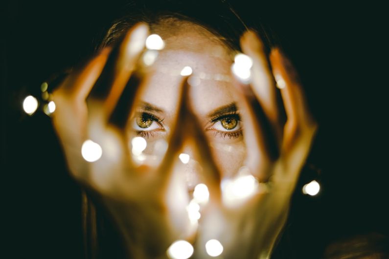 Dark Circles - woman holding string lights