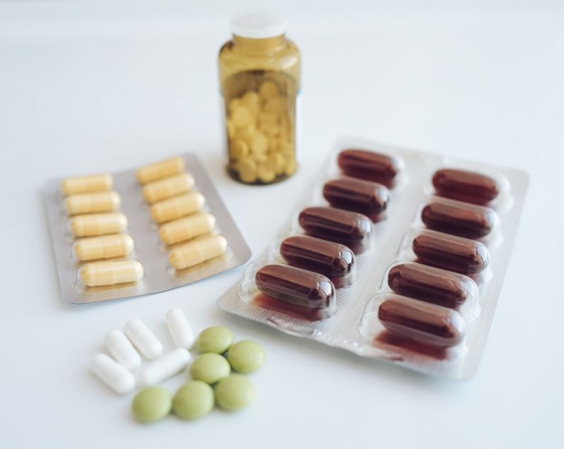 Checkups - a table topped with pills and a bottle of pills